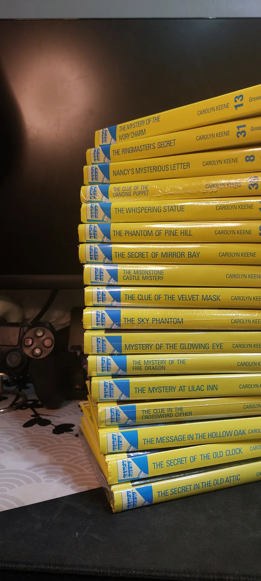 A much longer row of yellow Nancy Drew spines fanned out along a shelf