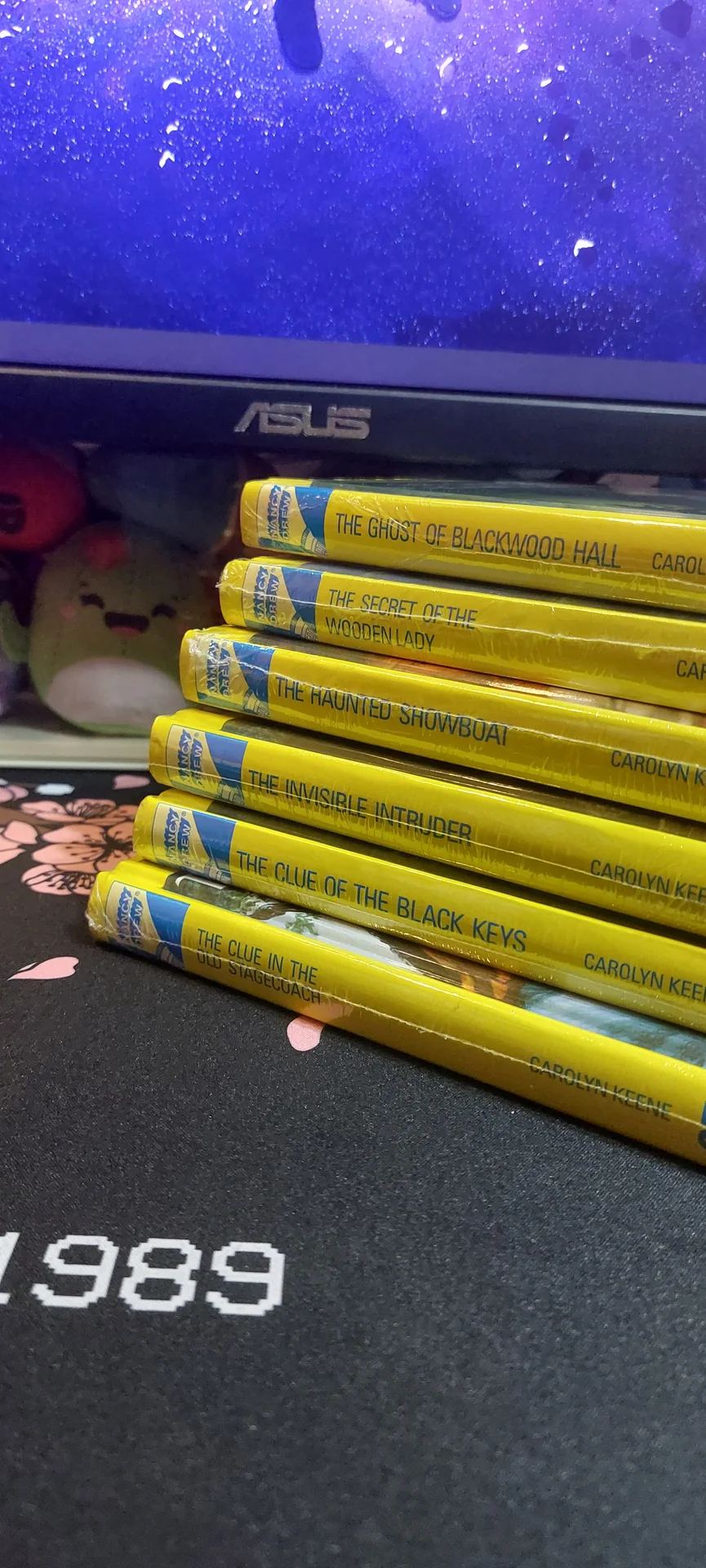 The shelf growing further, spines now numbered into the 50s