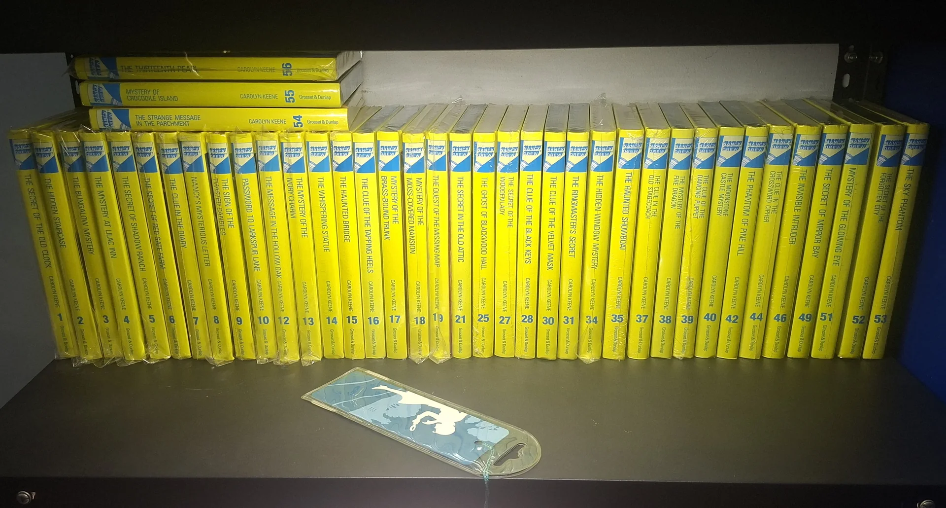 The full shelf of Nancy Drew spines lined up from number 1 to 53