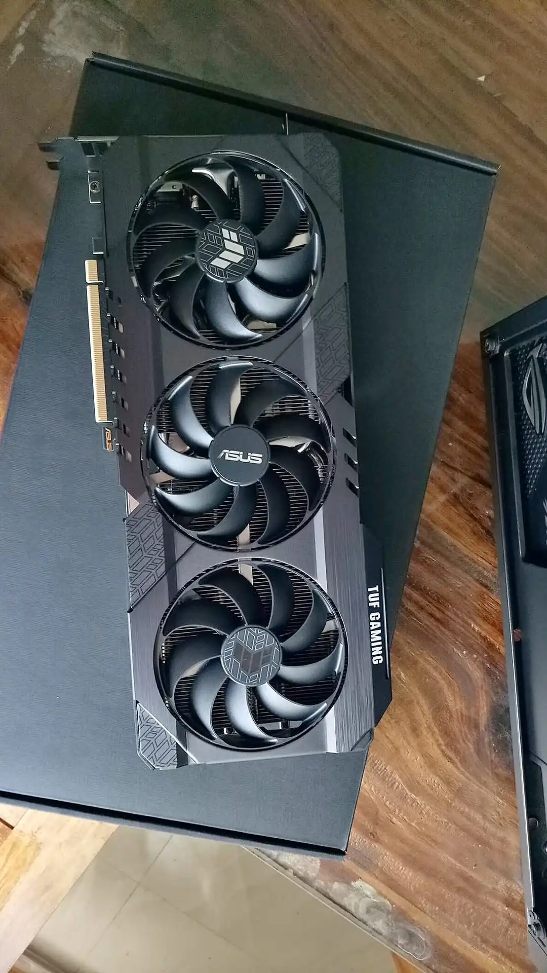 The ASUS TUF Gaming RTX 3060 Ti graphics card resting on its box