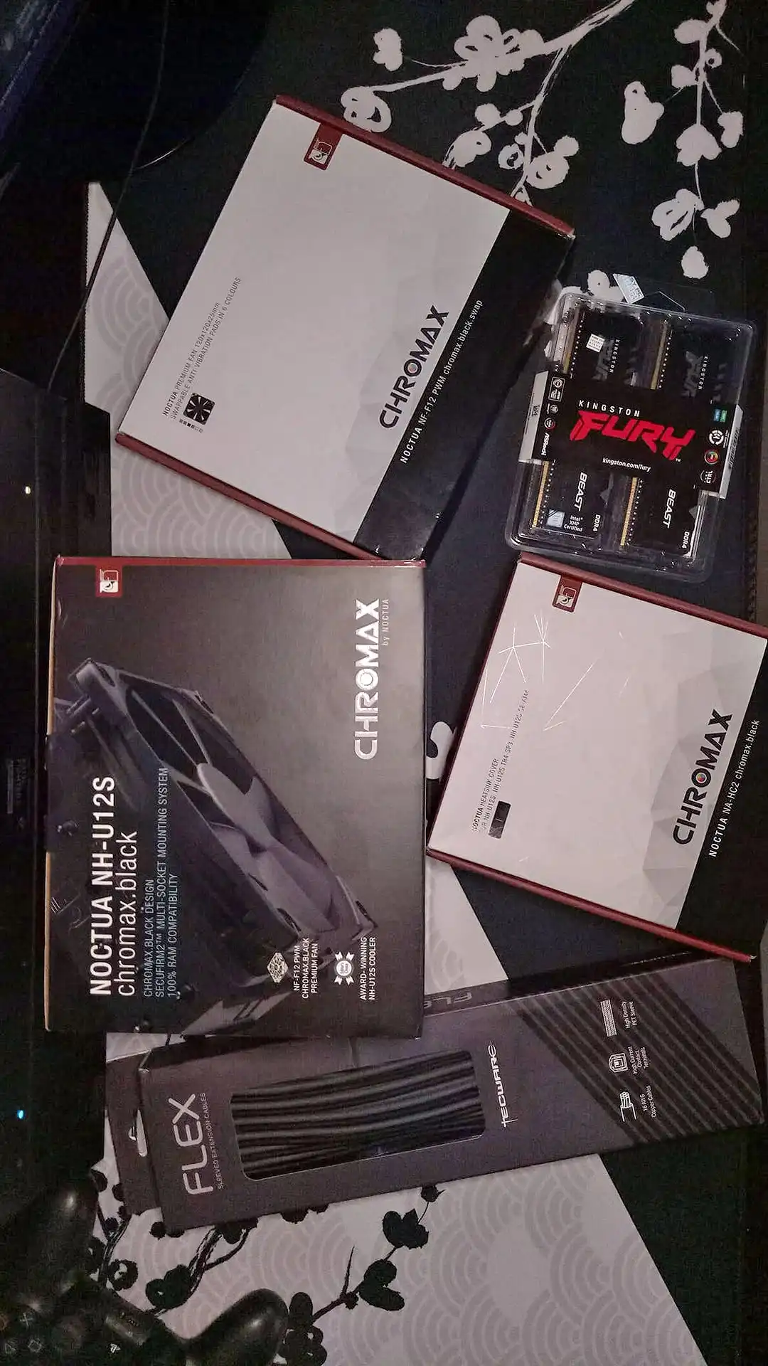 Noctua Chromax fans and CPU cooler, Kingston Fury RAM, and sleeved extension cables laid out before the build