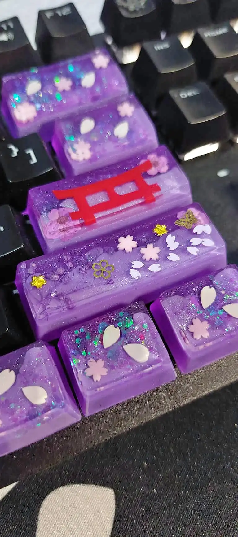 The full purple sakura resin keycap set, including a torii-gate keycap